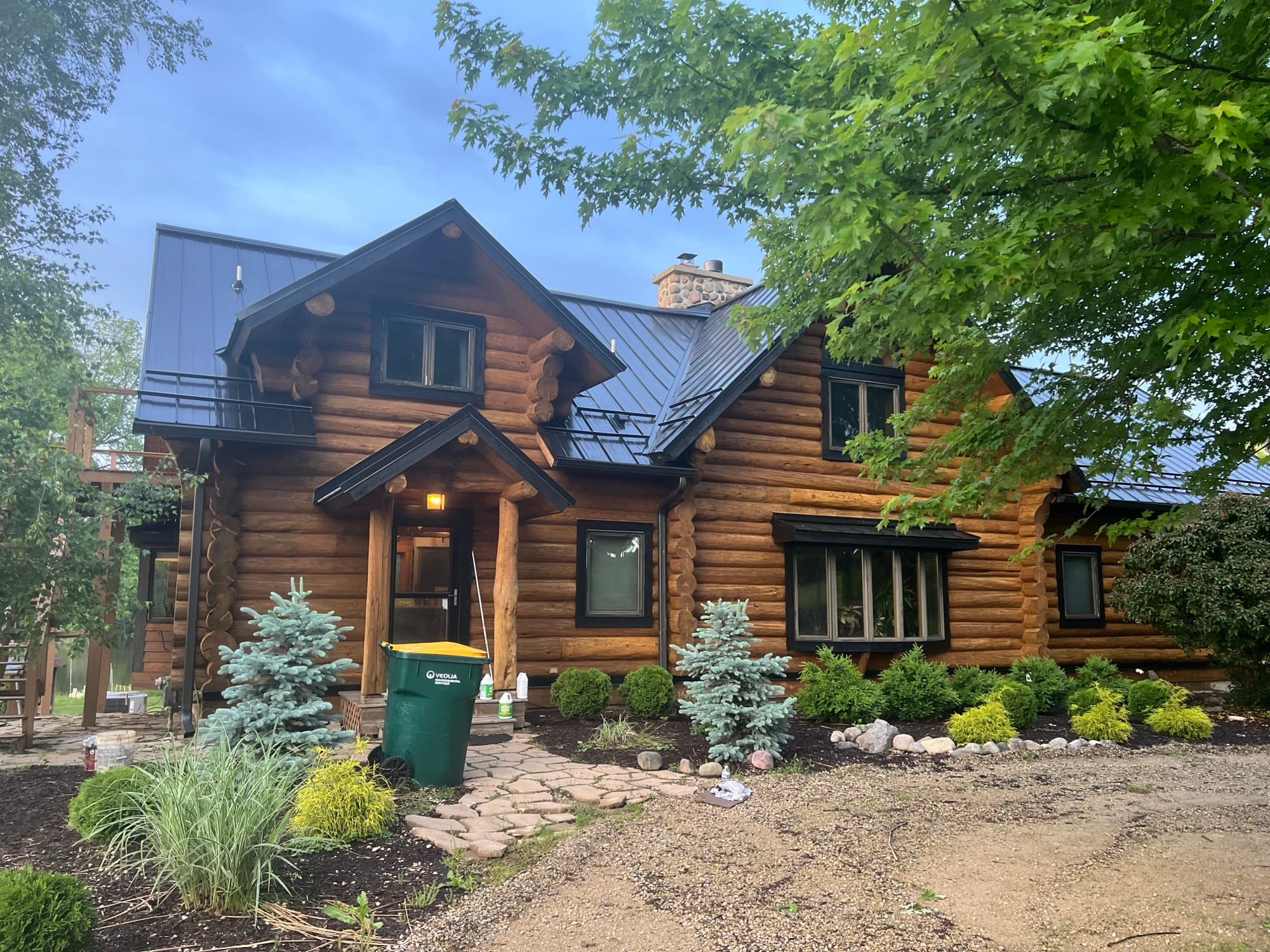 Log home exterior stained and restored by Property Restoration Solution