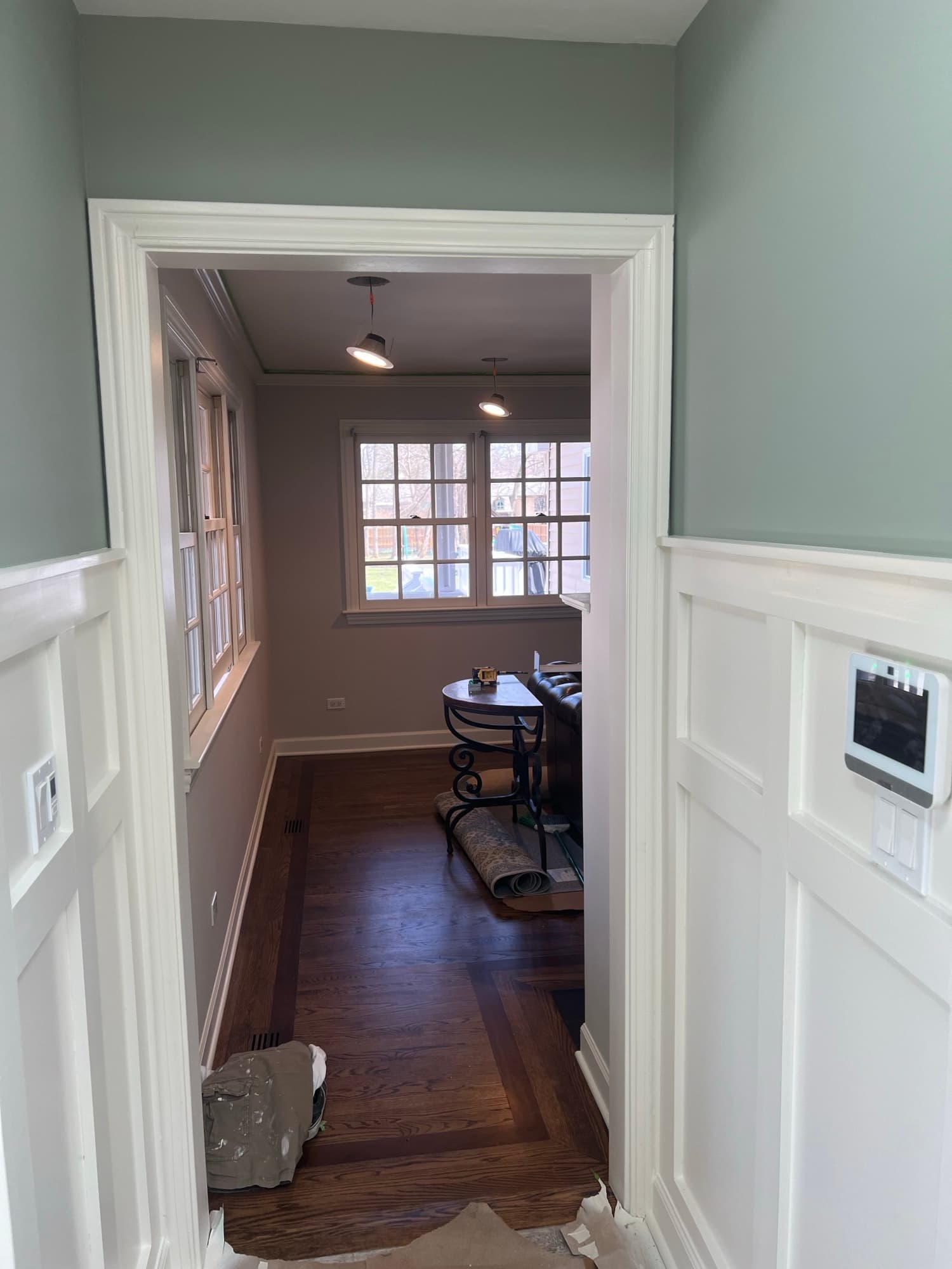 Sage walls white wainscoting hallway